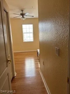 a view of a hallway with wooden floor