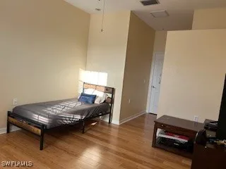 a bedroom with furniture and wooden floor