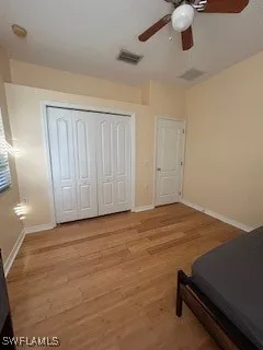 a view of room with air conditioner and ceiling fan