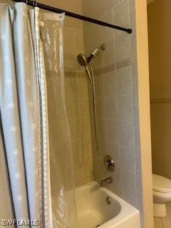 a bathroom with a tub and shower