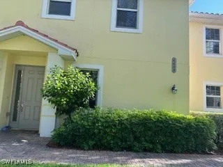 a view of a house with potted plants