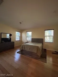 a bedroom with a bed and window