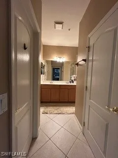 a bathroom with a sink shower and a mirror