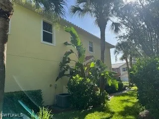 front view of a house with a yard and an trees