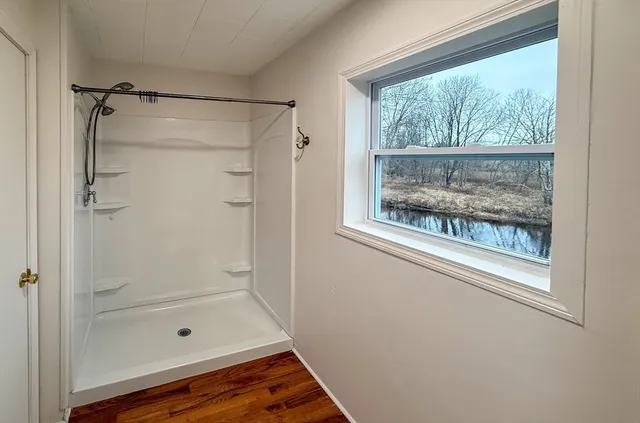 a bathroom with a glass shower door