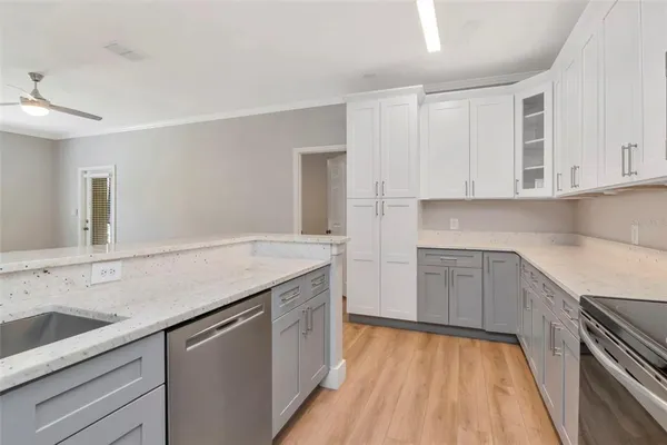 a kitchen with sink cabinets and wooden floor