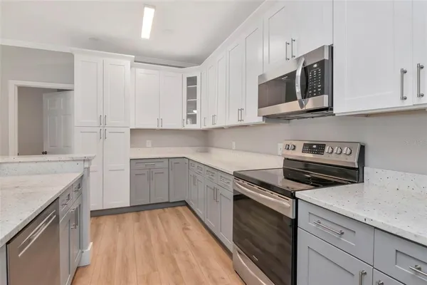 a kitchen with stainless steel appliances granite countertop a sink and a stove top oven