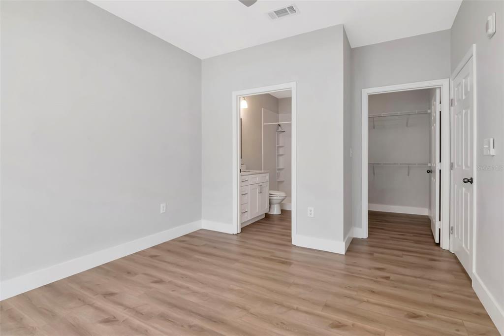 9916 Courtney Palms Boulevard, Unit 103 Tampa, FL 33619 - Photo 15 of 28 a view of an empty room with wooden floor and closet