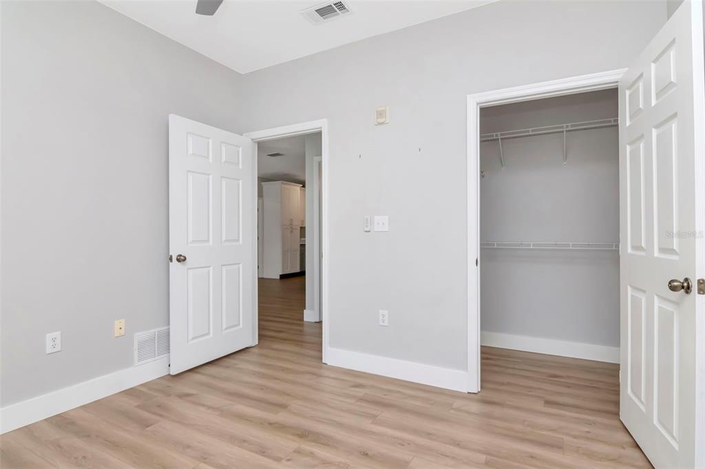 9916 Courtney Palms Boulevard, Unit 103 Tampa, FL 33619 - Photo 20 of 28 a view of an empty room with wooden floor & closet