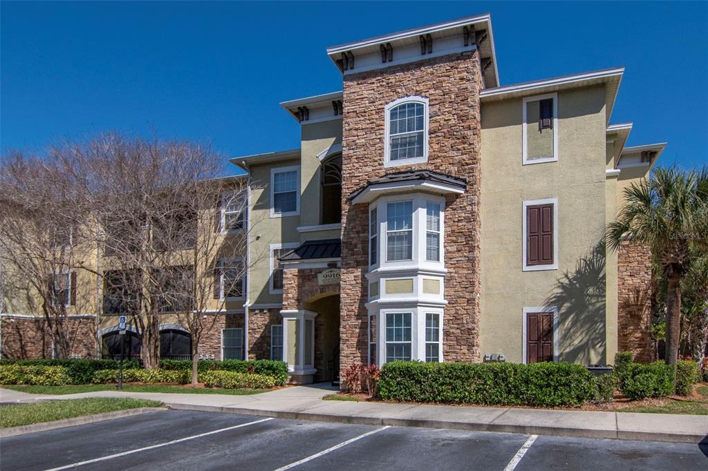9916 Courtney Palms Boulevard, Unit 103 Tampa, FL 33619 - Photo 2 of 28 a front view of a house with a yard