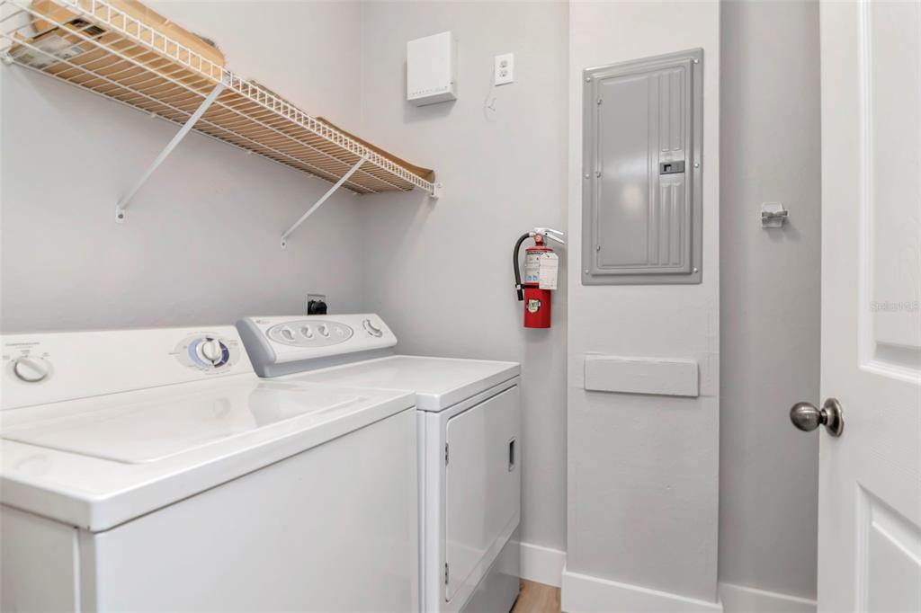 9916 Courtney Palms Boulevard, Unit 103 Tampa, FL 33619 - Photo 24 of 28 a utility room with dryer and washer