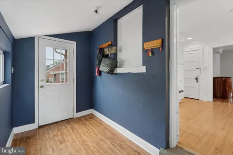 a view of a bedroom with wooden floor and cabinet