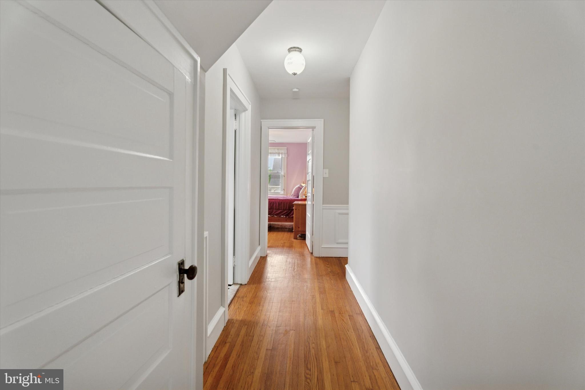 1442 Dorchester Road Havertown, PA 19083 - Photo 16 of 45 a view of a hallway with wooden floor and a bathroom