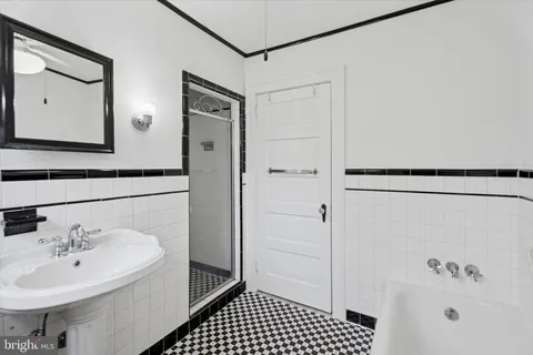 a bathroom with a sink a mirror and shower