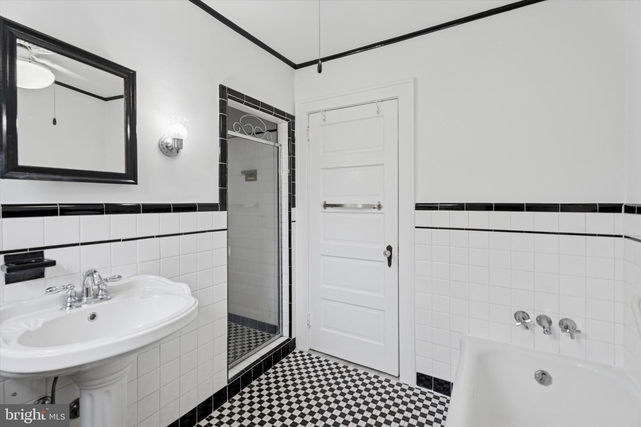 1442 Dorchester Road Havertown, PA 19083 - Photo 20 of 45 a bathroom with a sink a mirror and shower