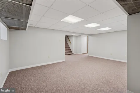 an empty room with a hallway and stairs