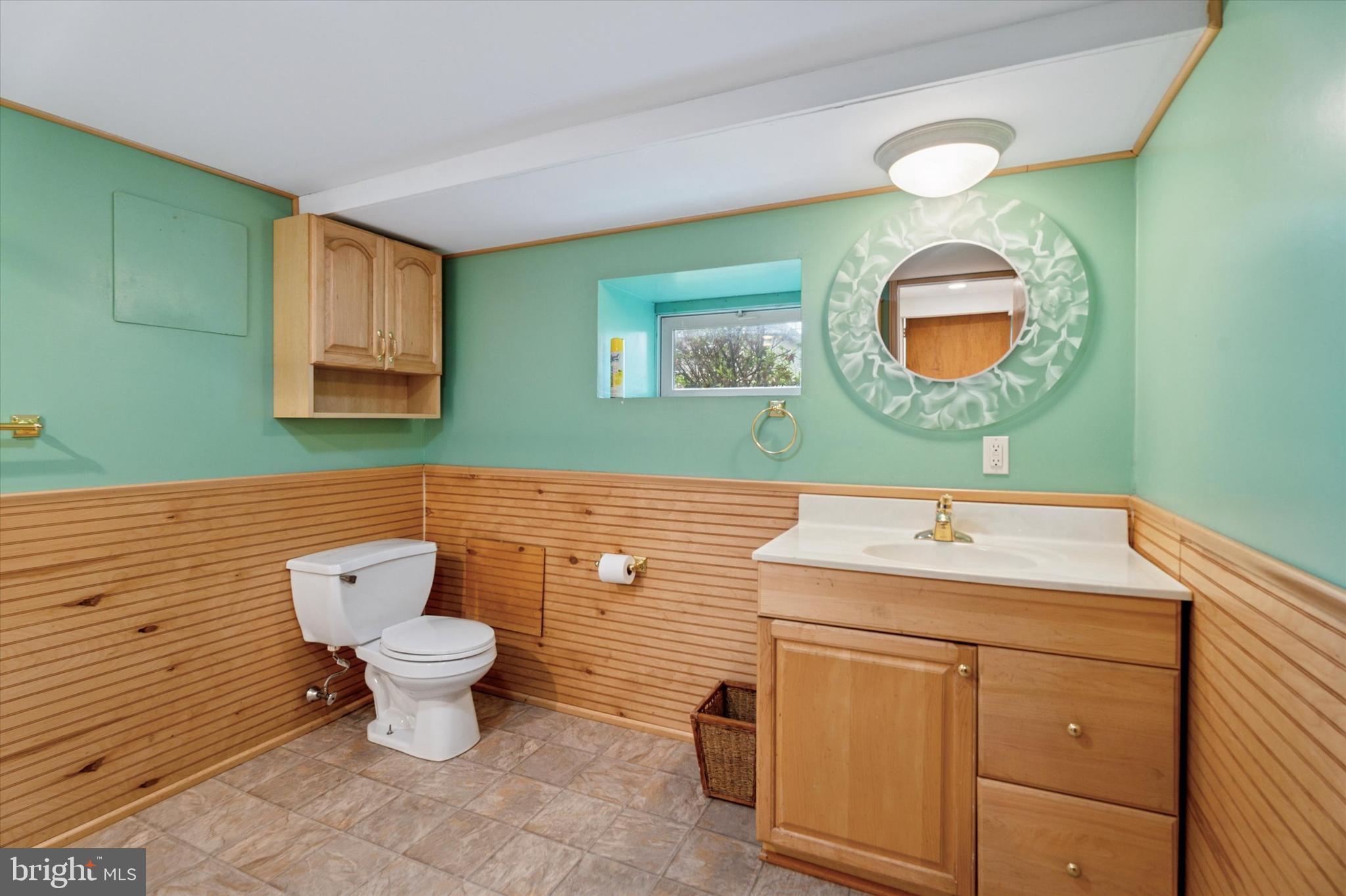 1442 Dorchester Road Havertown, PA 19083 - Photo 36 of 45 a bathroom with a toilet sink and mirror