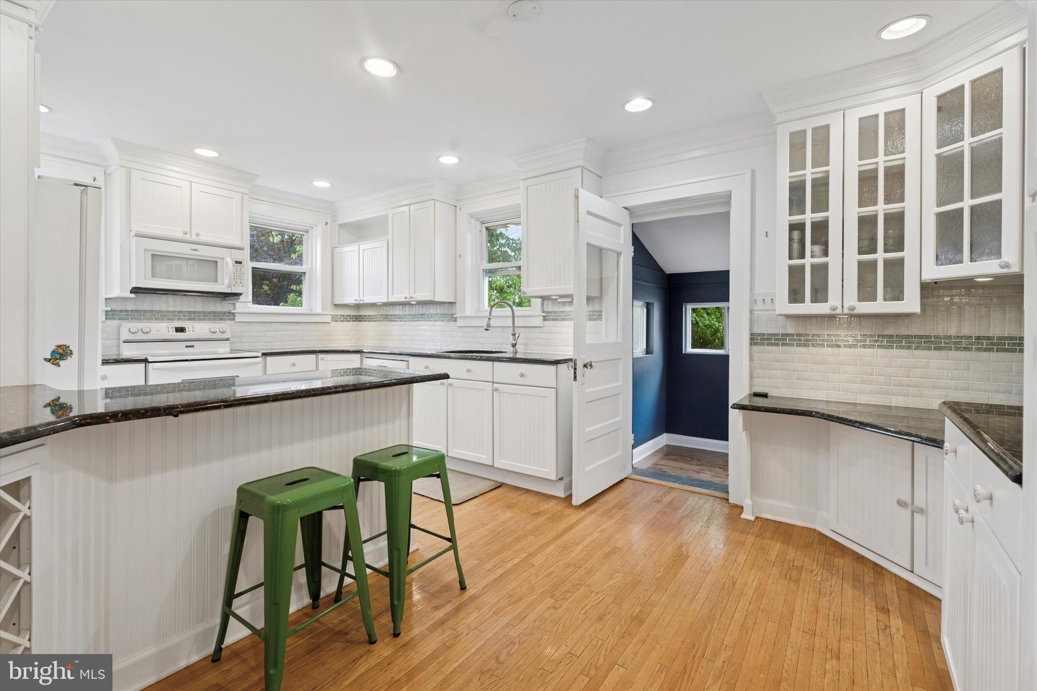 1442 Dorchester Road Havertown, PA 19083 - Photo 10 of 45 a kitchen with stainless steel appliances granite countertop wooden cabinets a sink a stove a dining table and chairs