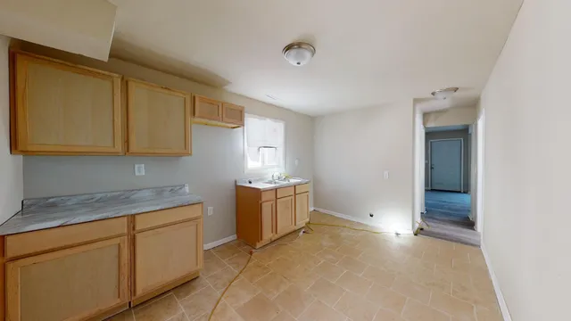 an empty room with wooden floor and closet