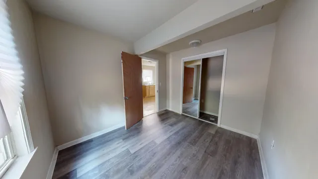 a view of hallway with wooden floor