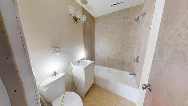 a bathroom with a toilet and a shower