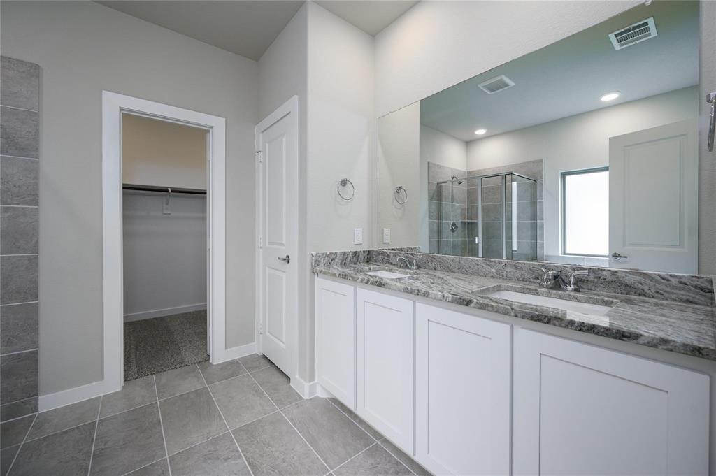 412 Heritage Grove Road Blue Ridge, TX 75424 - Photo 11 of 20 a bathroom with a granite countertop sink and a mirror