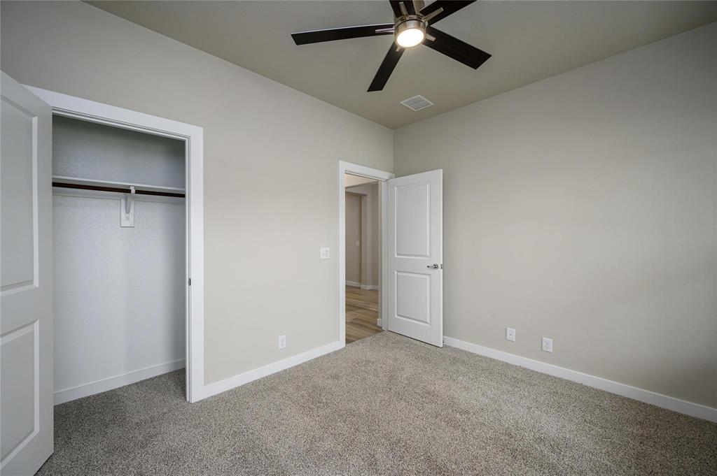412 Heritage Grove Road Blue Ridge, TX 75424 - Photo 16 of 20 an empty room with closet and a chandelier fan