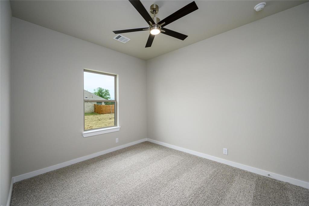 412 Heritage Grove Road Blue Ridge, TX 75424 - Photo 17 of 20 an empty room with a window and a fan
