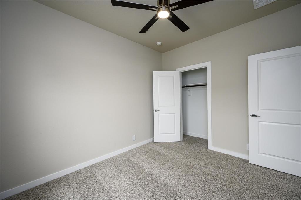 412 Heritage Grove Road Blue Ridge, TX 75424 - Photo 19 of 20 an empty room with a ceiling fan and window