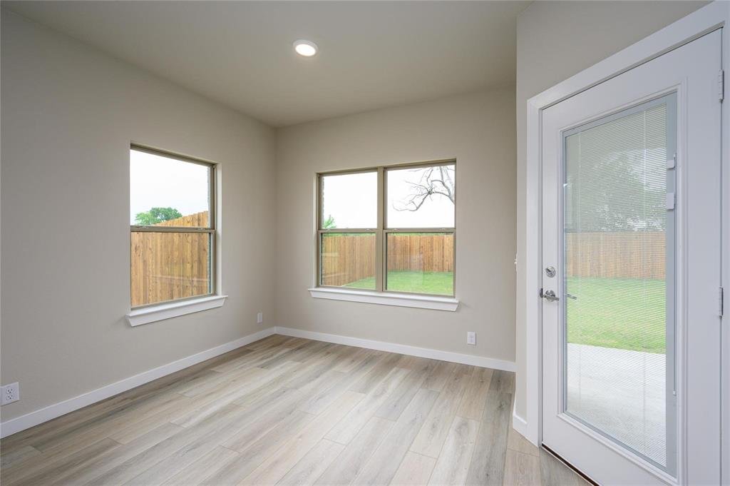 412 Heritage Grove Road Blue Ridge, TX 75424 - Photo 6 of 20 an empty room with wooden floor and windows