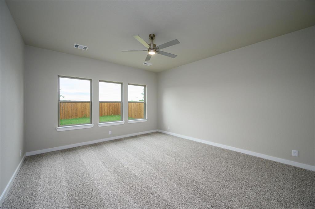 412 Heritage Grove Road Blue Ridge, TX 75424 - Photo 9 of 20 an empty room with chandelier fan and windows