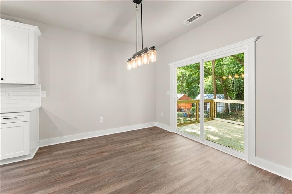 43 Anderson Street Jefferson, GA 30549 - Photo 11 of 45 a view of a room with wooden floor garden view and a chandelier