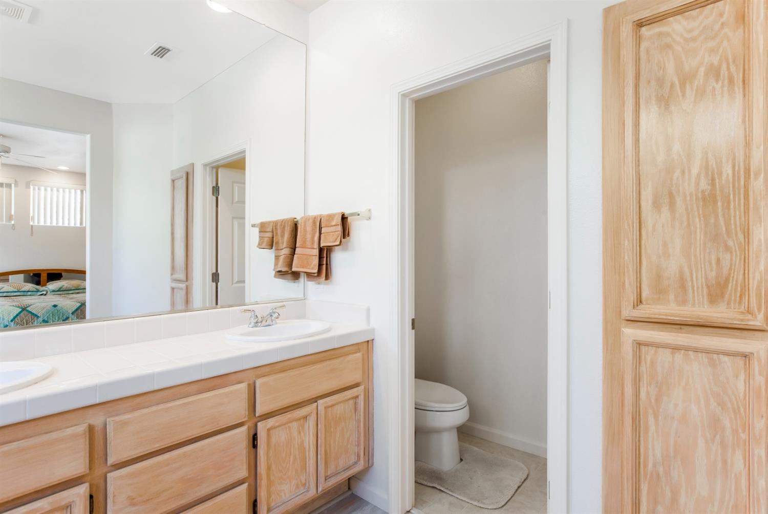 1160 Cobblefields Court Folsom, CA 95630 - Photo 20 of 26 a bathroom with a granite countertop sink toilet and shower