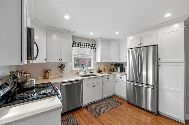 a kitchen with a sink stainless steel appliances and cabinets