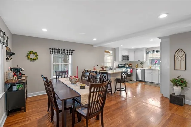 a view of a dining room with furniture and wooden floor