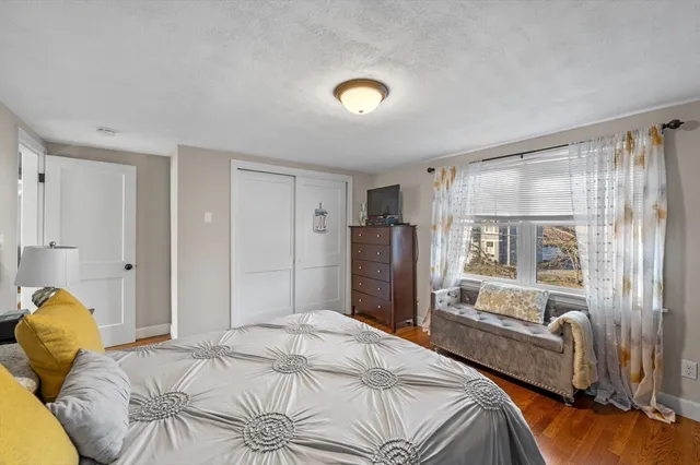 a bedroom with a bed and wooden cabinets