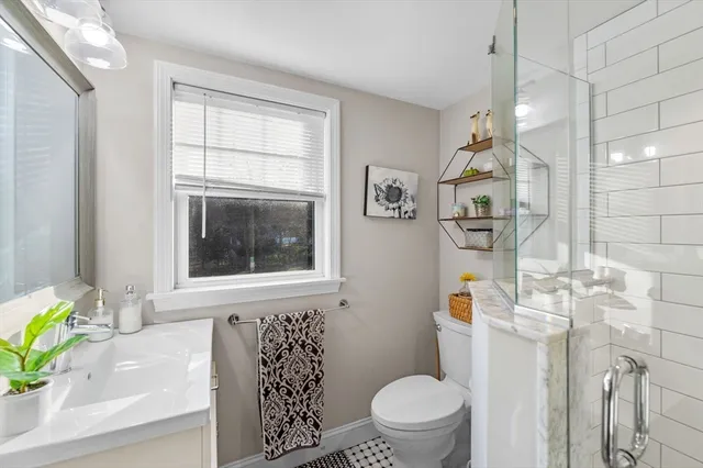 a bathroom with a toilet sink and mirror