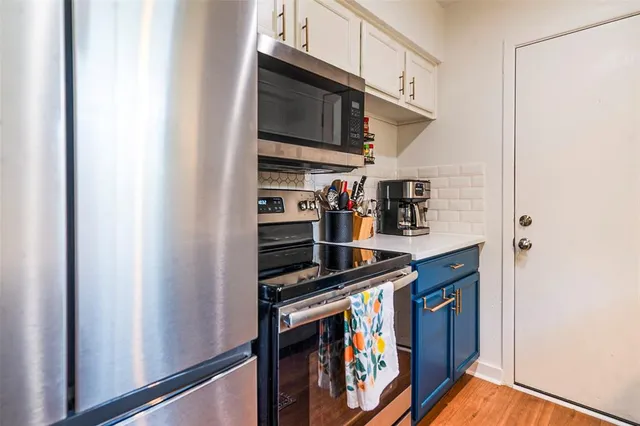 a kitchen with stainless steel appliances a stove and a refrigerator