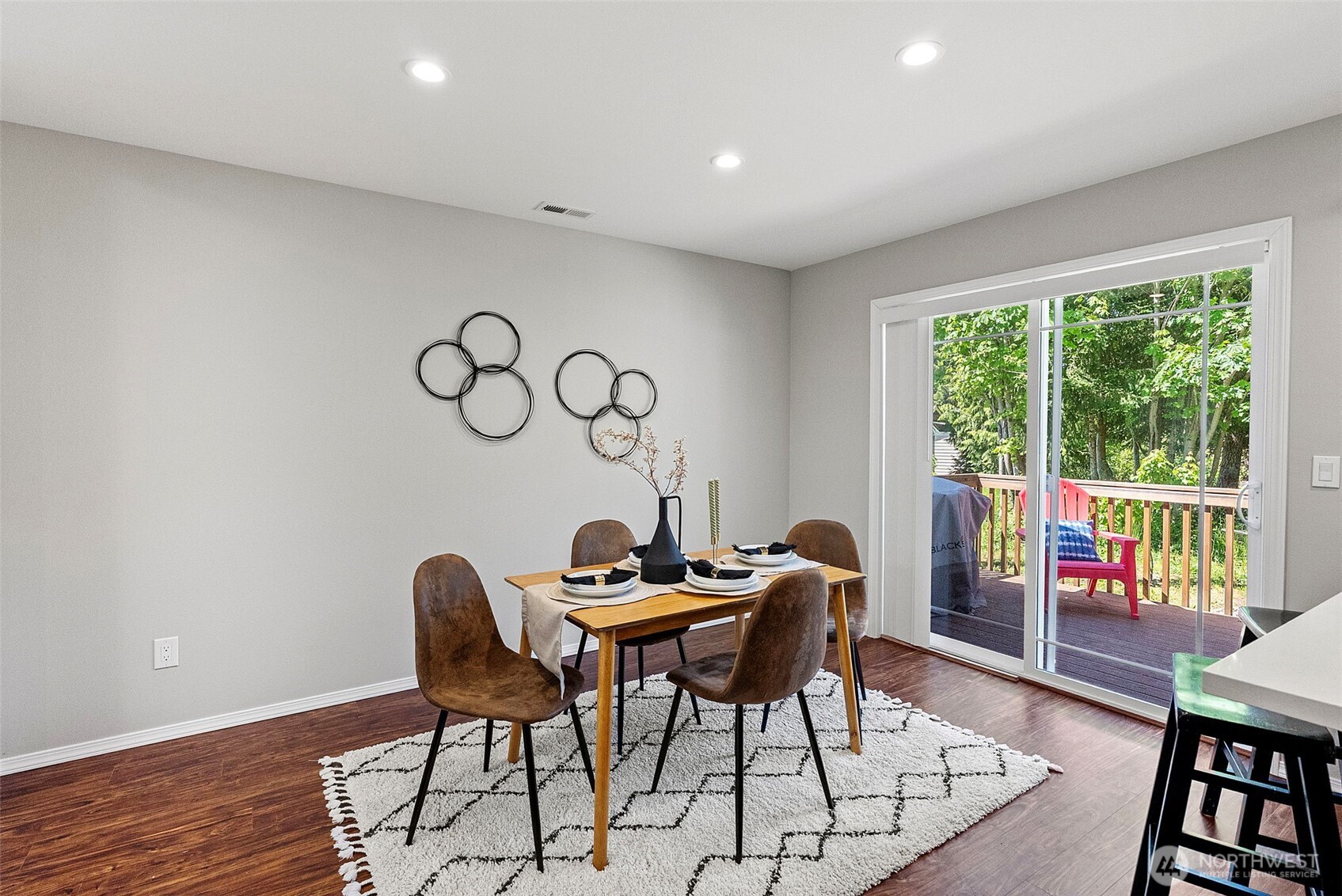 40 Northeast Eagle Crest Place Belfair, WA 98528 - Photo 11 of 27 a dining room with furniture wooden floor and a rug