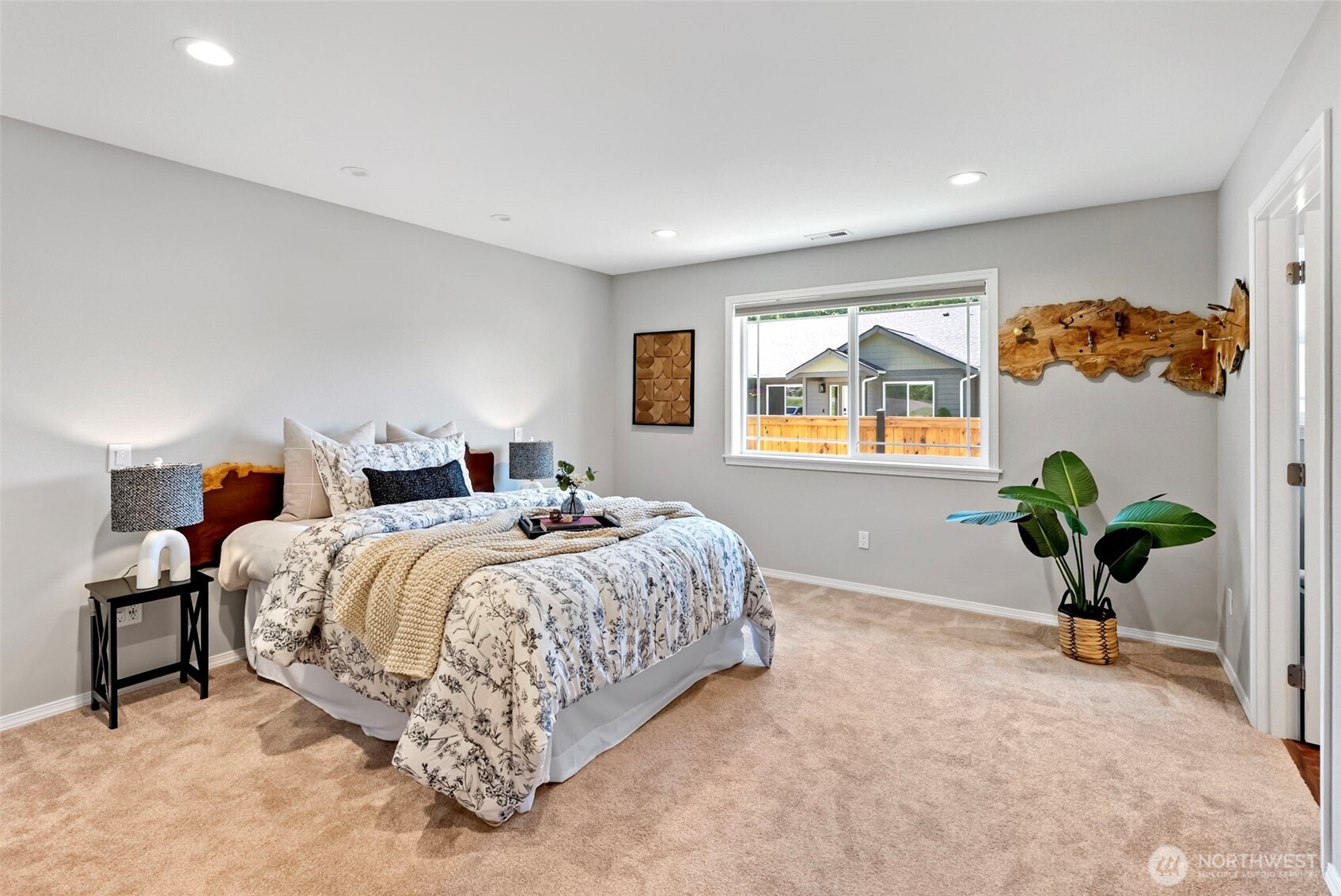 40 Northeast Eagle Crest Place Belfair, WA 98528 - Photo 12 of 27 a spacious bedroom with a bed and a potted plant