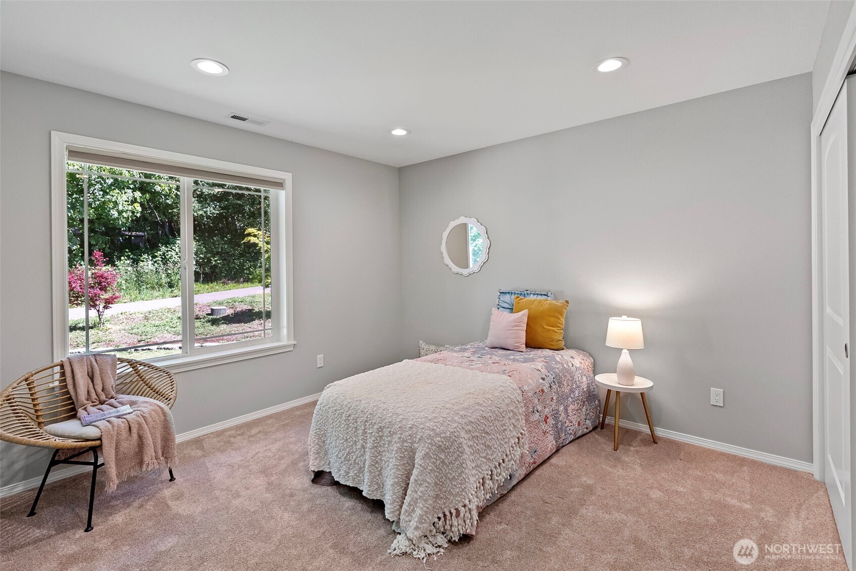 40 Northeast Eagle Crest Place Belfair, WA 98528 - Photo 17 of 27 a bedroom with a bed and a chair