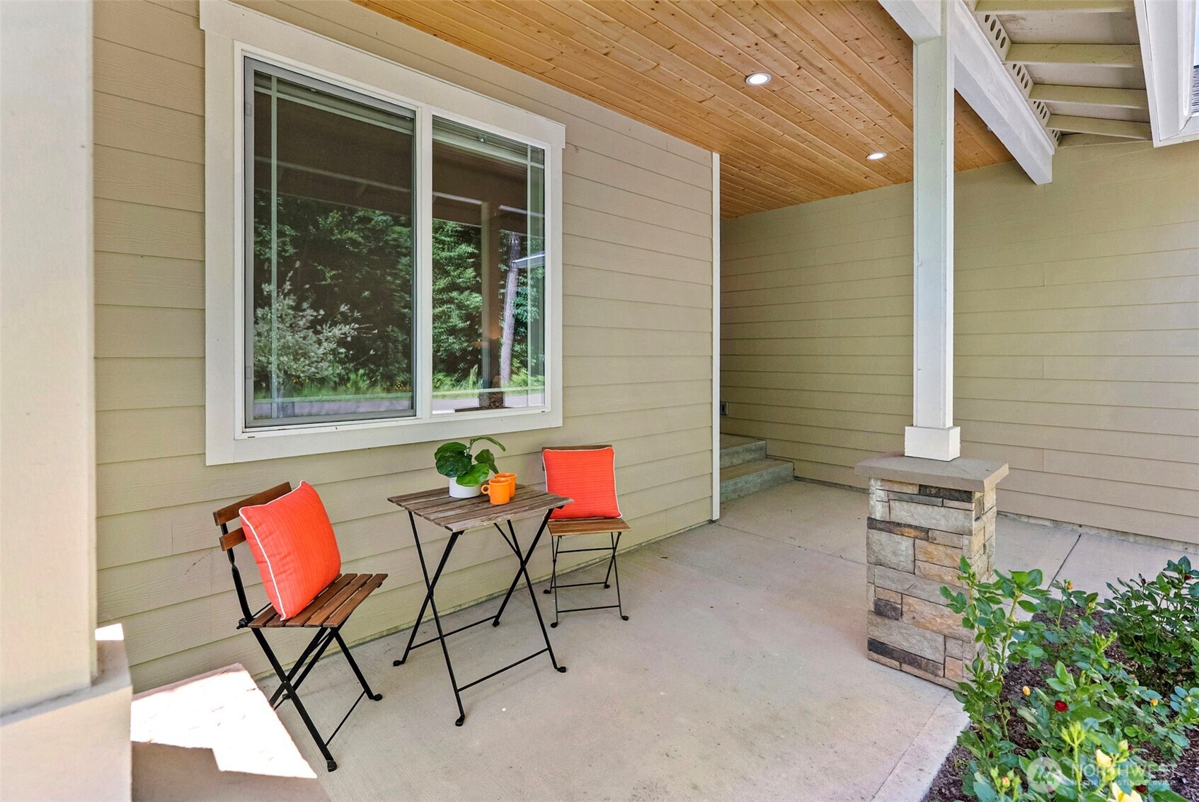 40 Northeast Eagle Crest Place Belfair, WA 98528 - Photo 2 of 27 a backyard of a house with barbeque oven table and chairs