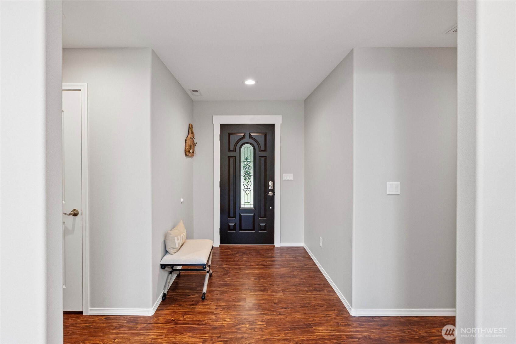 40 Northeast Eagle Crest Place Belfair, WA 98528 - Photo 3 of 27 a view of a hallway with wooden floor and a bathroom