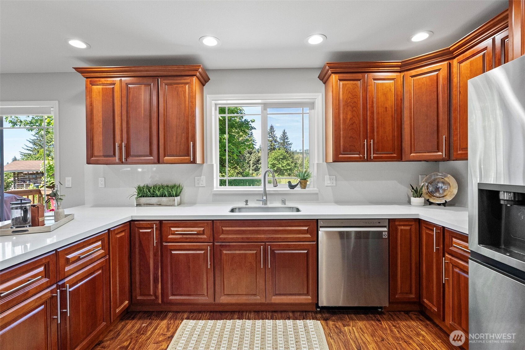 40 Northeast Eagle Crest Place Belfair, WA 98528 - Photo 8 of 27 a kitchen with stainless steel appliances granite countertop wooden cabinets a sink and a stove