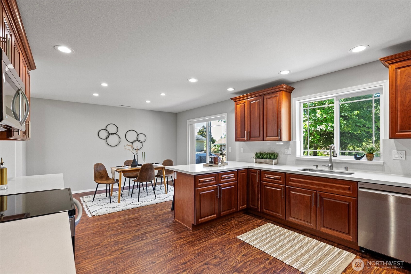 40 Northeast Eagle Crest Place Belfair, WA 98528 - Photo 9 of 27 a kitchen with lots of counter top space and dining table