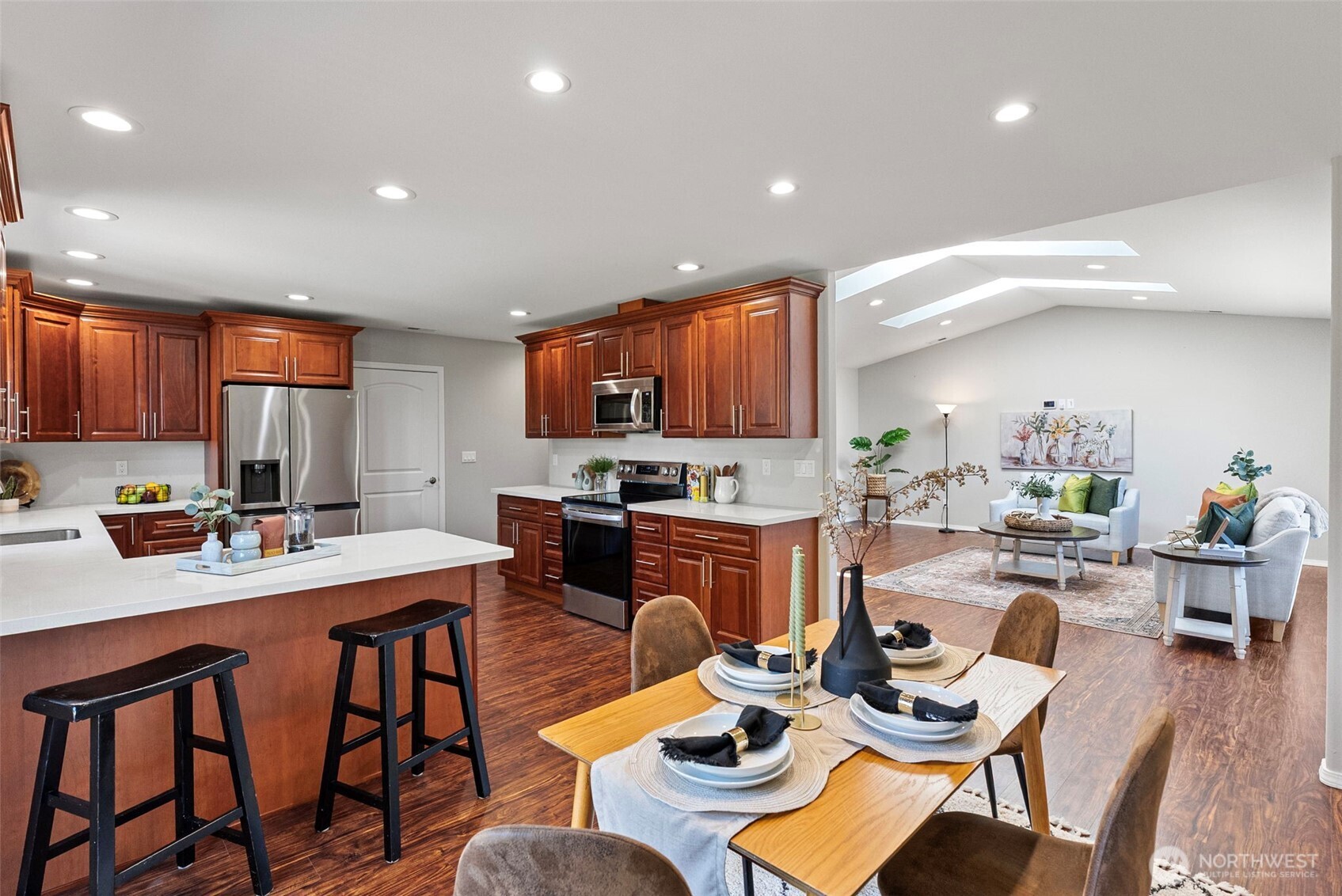 40 Northeast Eagle Crest Place Belfair, WA 98528 - Photo 10 of 27 a open dining room with stainless steel appliances kitchen island granite countertop a dining table and chairs