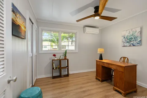 a view of a livingroom with a window and wooden floor