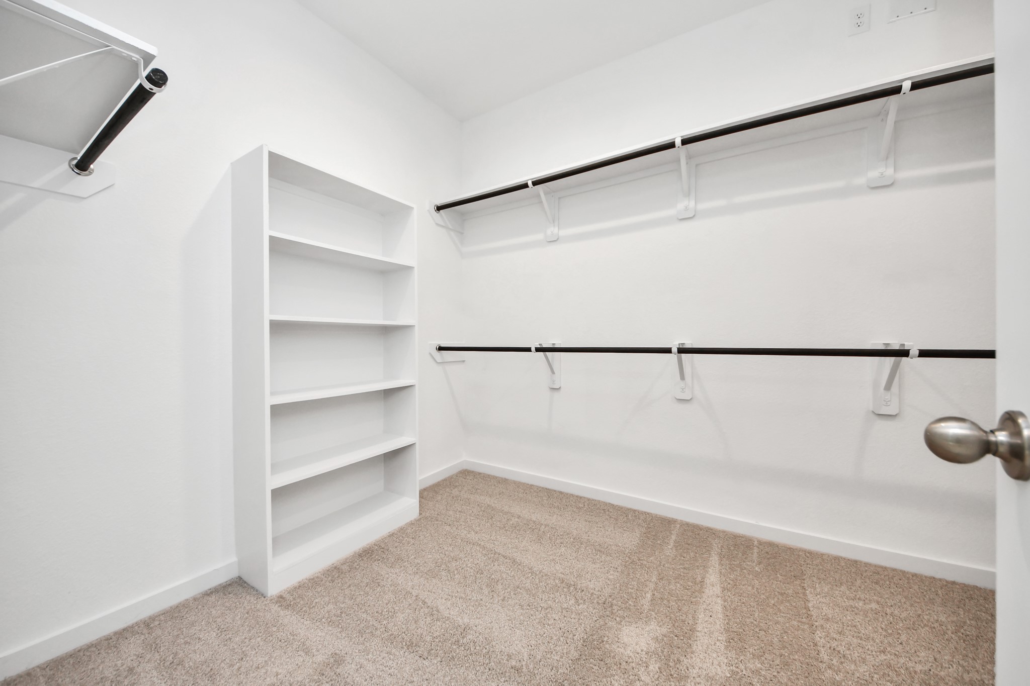 2926 Bury Park Dr Spring Spring, TX 77373 - Photo 22 of 40 Walk-in closet that epitomizes luxury and practicality. This generously sized space features built-in shelving, offering abundant room for impeccable organization. High ceilings and recessed lighting create a bright and welcoming ambiance.