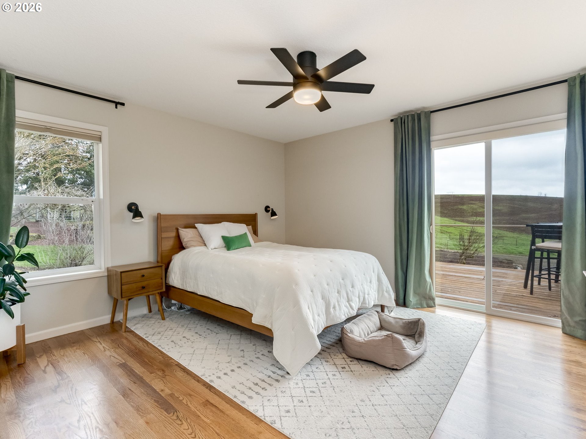 33100 Southeast Gunderson Road Boring, OR 97009 - Photo 13 of 48 a bedroom with a bed and a large window with wooden floor