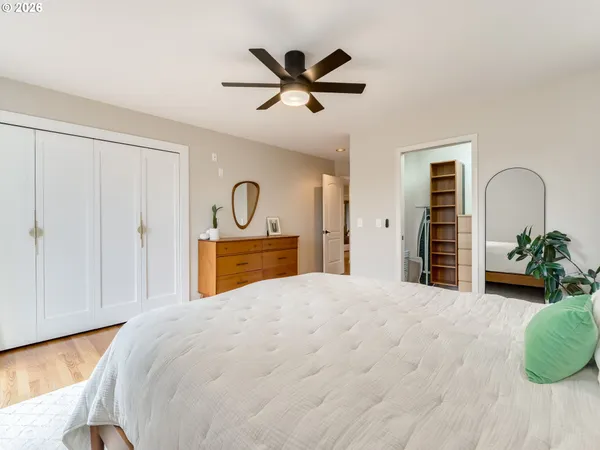 a bed room with a bed and a ceiling fan